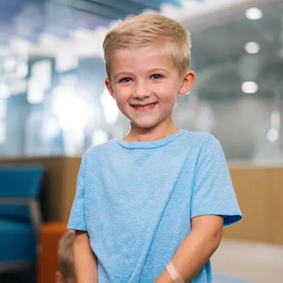 Young boy smiling in Children's Nebraska lobby.