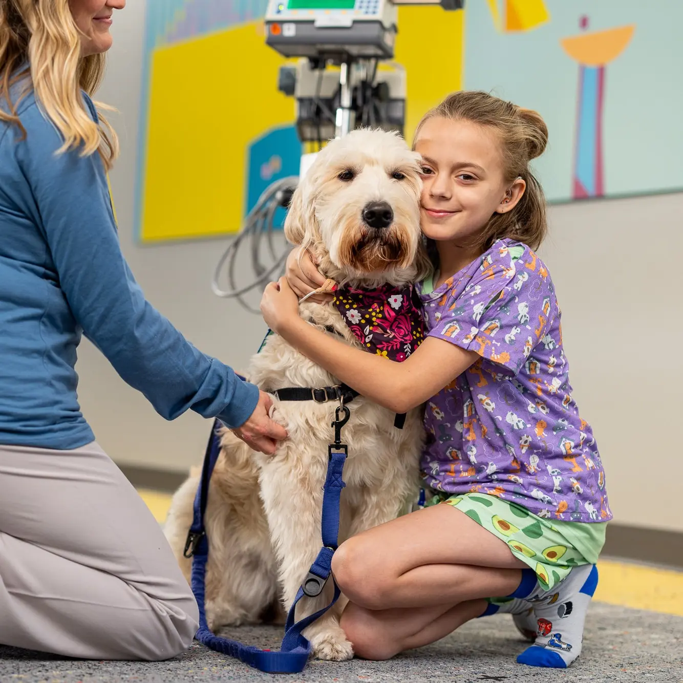 Young patient at Children's Nebraska hugging the therapy dog.