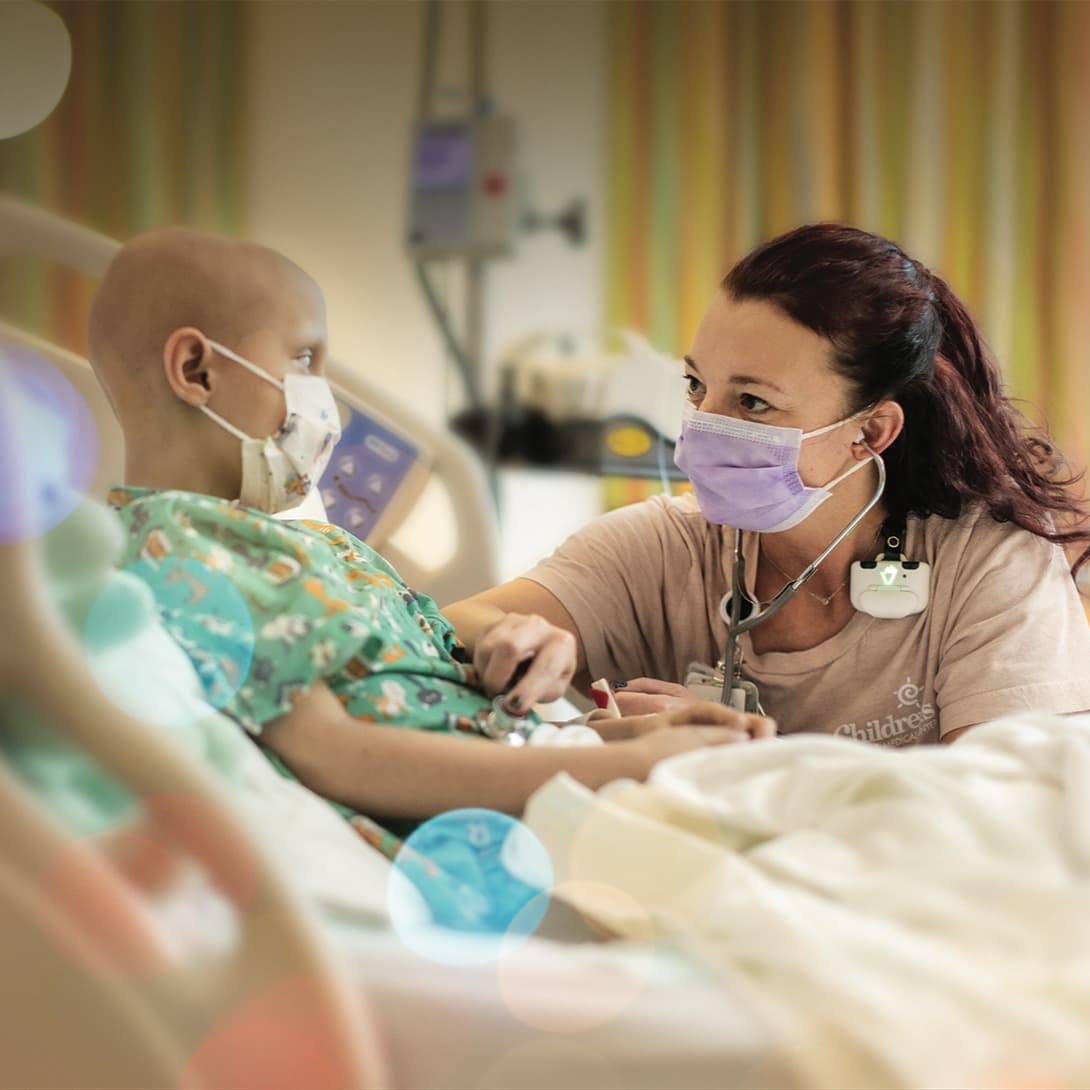 Children's Nebraska provider comforting a young cancer patient.