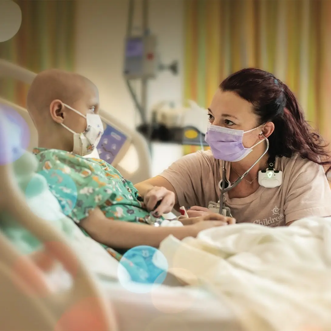 Children's Nebraska provider comforting a young cancer patient.