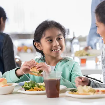 Mother and daughter enjoying a meal together.