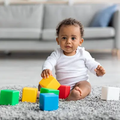 Child playing with toys on floor.