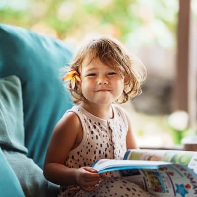 Young girl reading book.