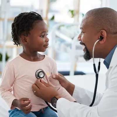 Provider examining young child.
