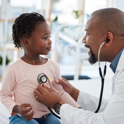 Provider examining young child.