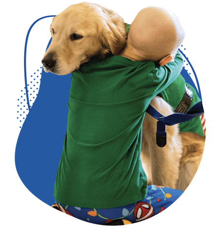 Young patient hugging Children's Nebraska facility dog.