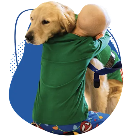 Young patient hugging Children's Nebraska facility dog.