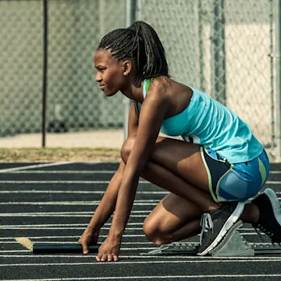 Girl running on track.