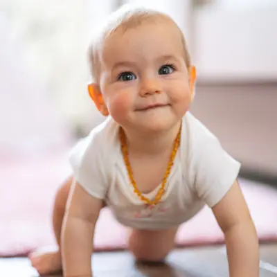 Infant smiling at camera.