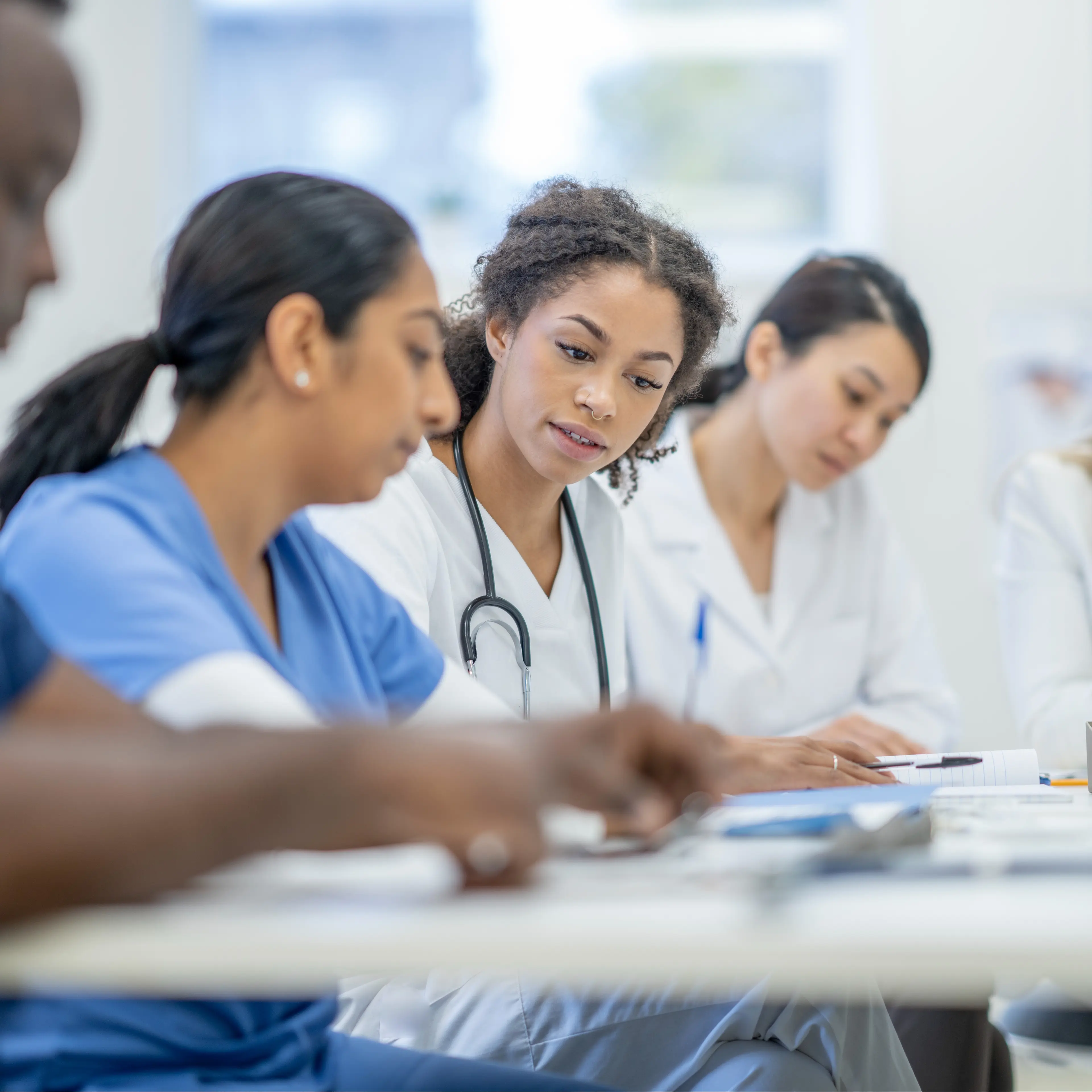 Group of medical professionals sitting at a table.