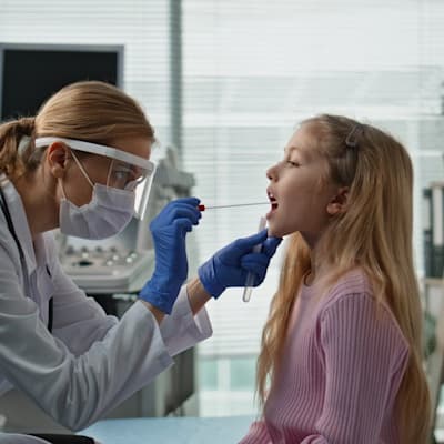 Provider swabbing young patient.