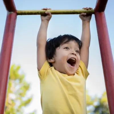 Young boy playing on playground.