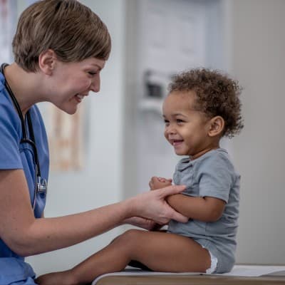 Young boy smiling at provider.