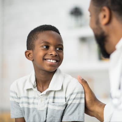 Happy boy smiling at provider.