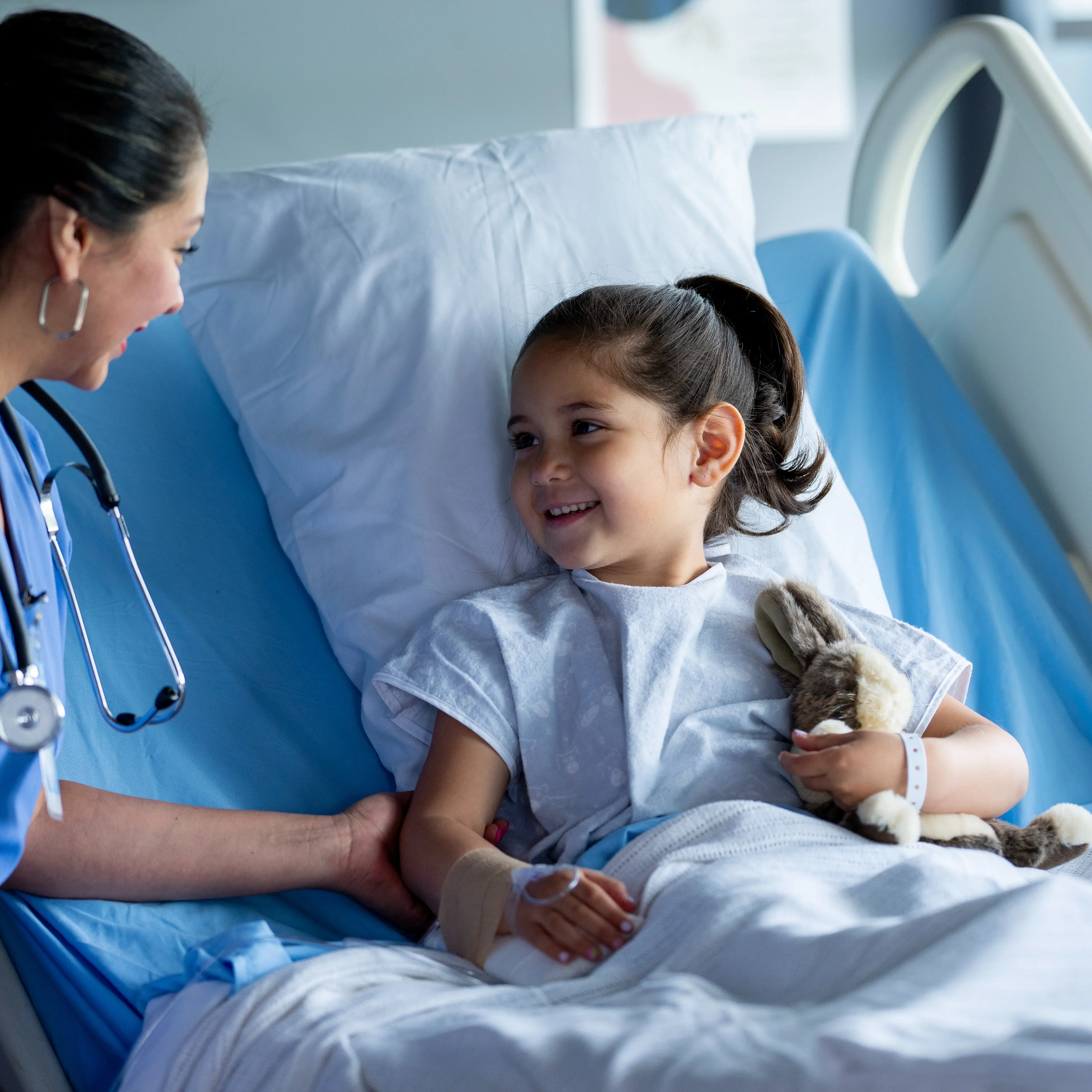 Provider caring for a young patient in the hospital.
