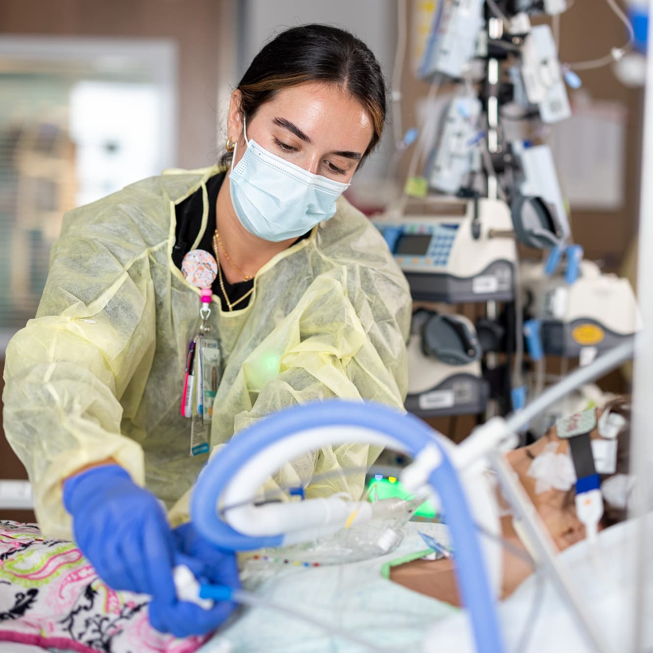 Trauma nurse caring for pediatric patient in pediatric level 1 trauma center.
