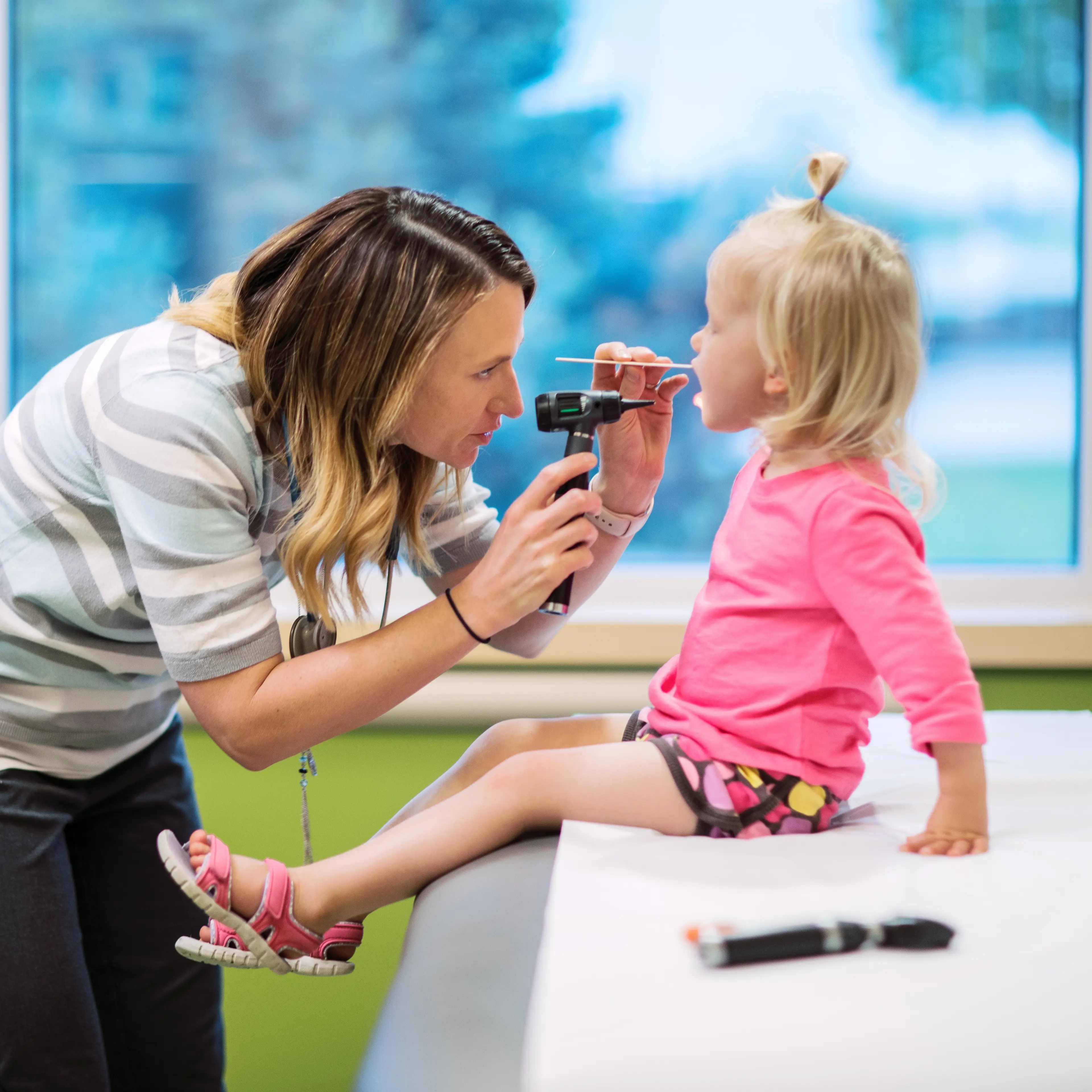 Primary Care provider examining young patient.