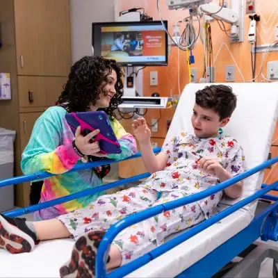 Nurse calming young patient before procedure.