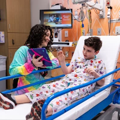 Nurse calming young patient before procedure.
