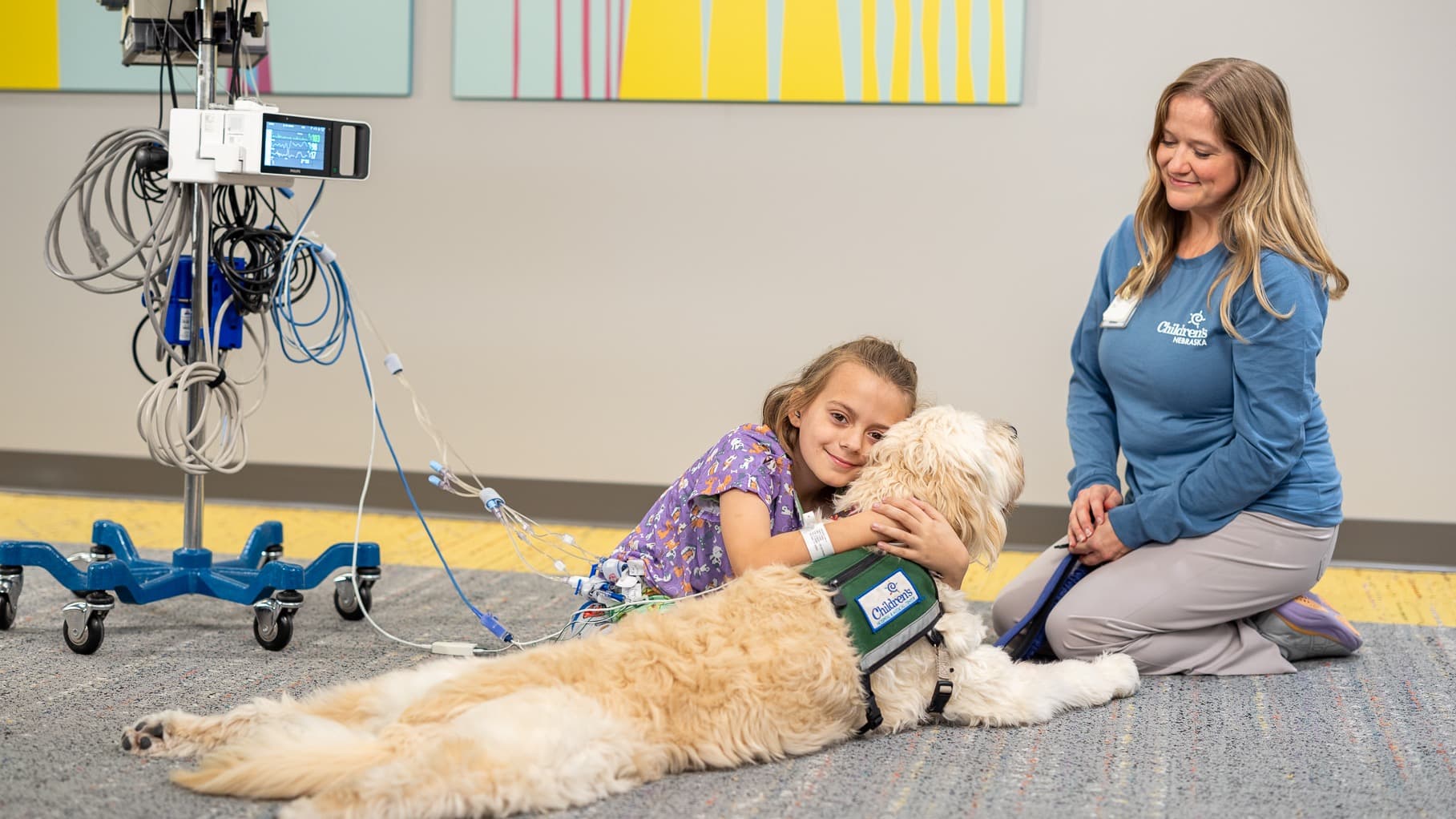 Young patient hugging pet therapy dog.