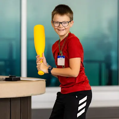 Children's Nebraska patient playing baseball in the atrium.
