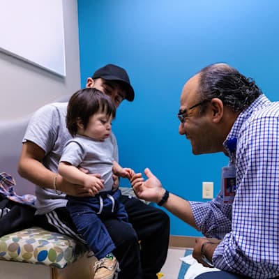 Children's provider smiling with young patient.