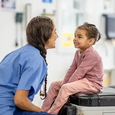 Provider smiling with young patient.