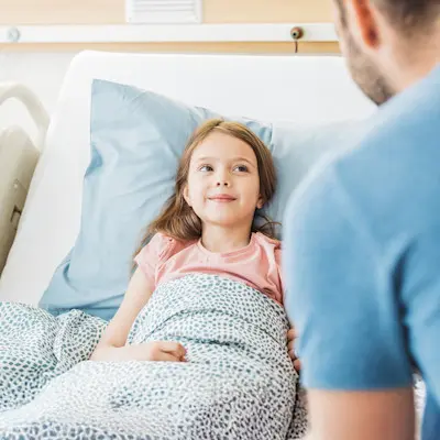 Young patient receiving dialysis treatment.
