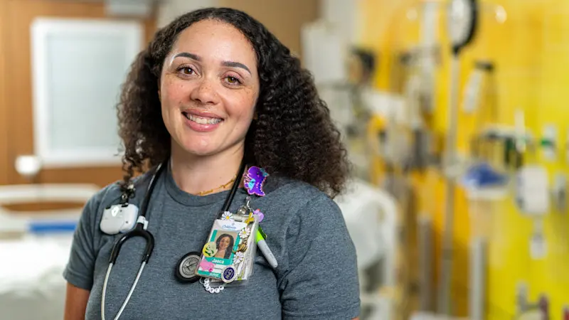 Children's Nurse smiling at camera in the Hubbard Center for Children.