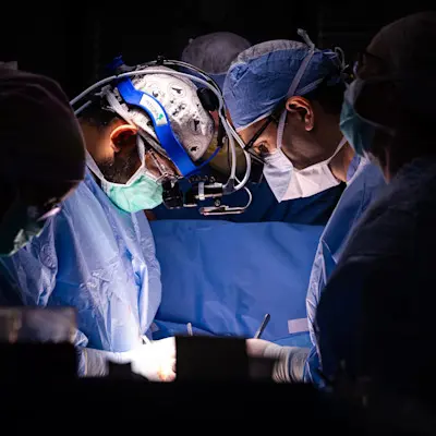 Doctor visiting patient in hospital room.