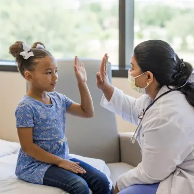 Provider giving high-five to a young patient.