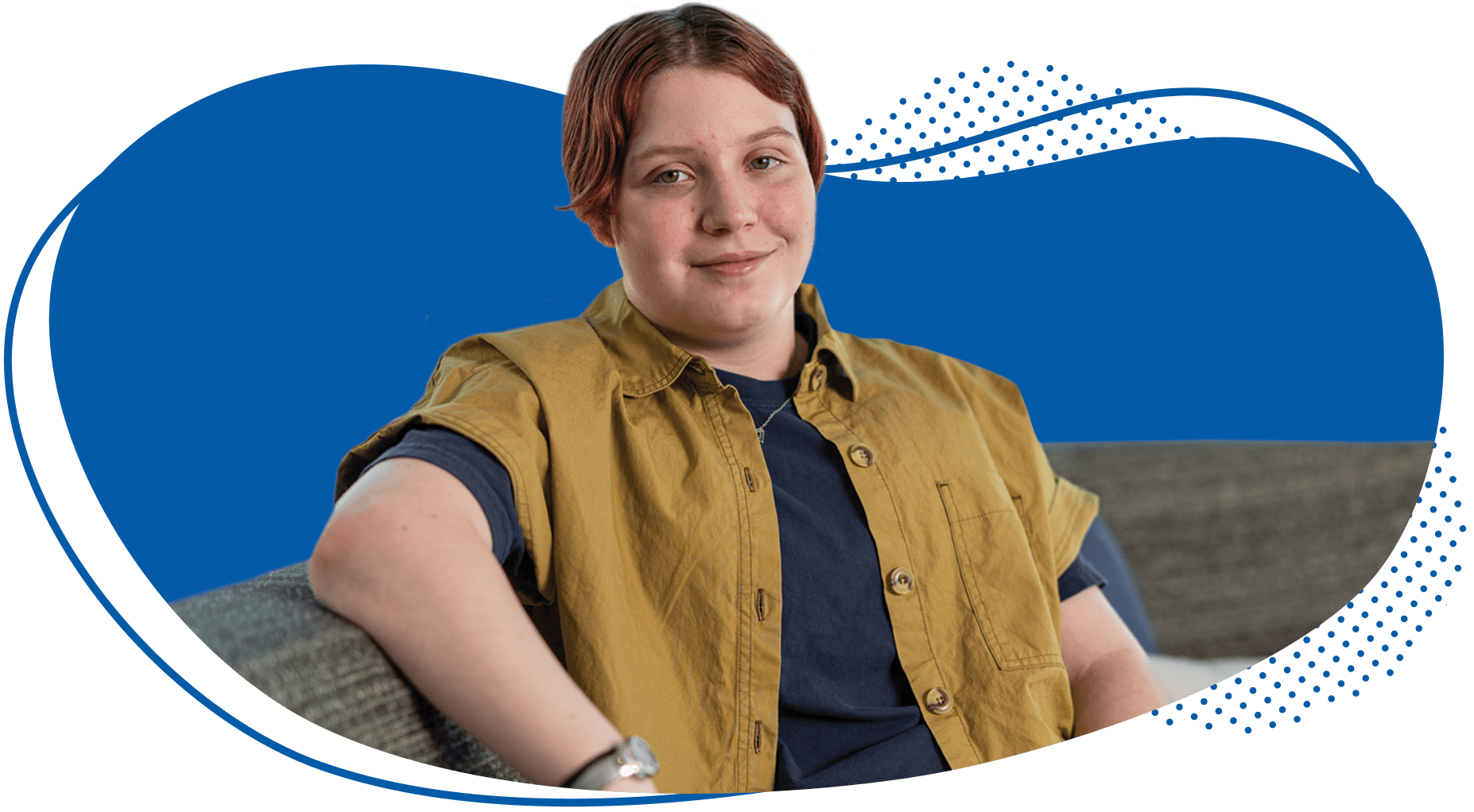 Person with short reddish hair wearing a tan vest over dark shirt against blue background with decorative wave design.