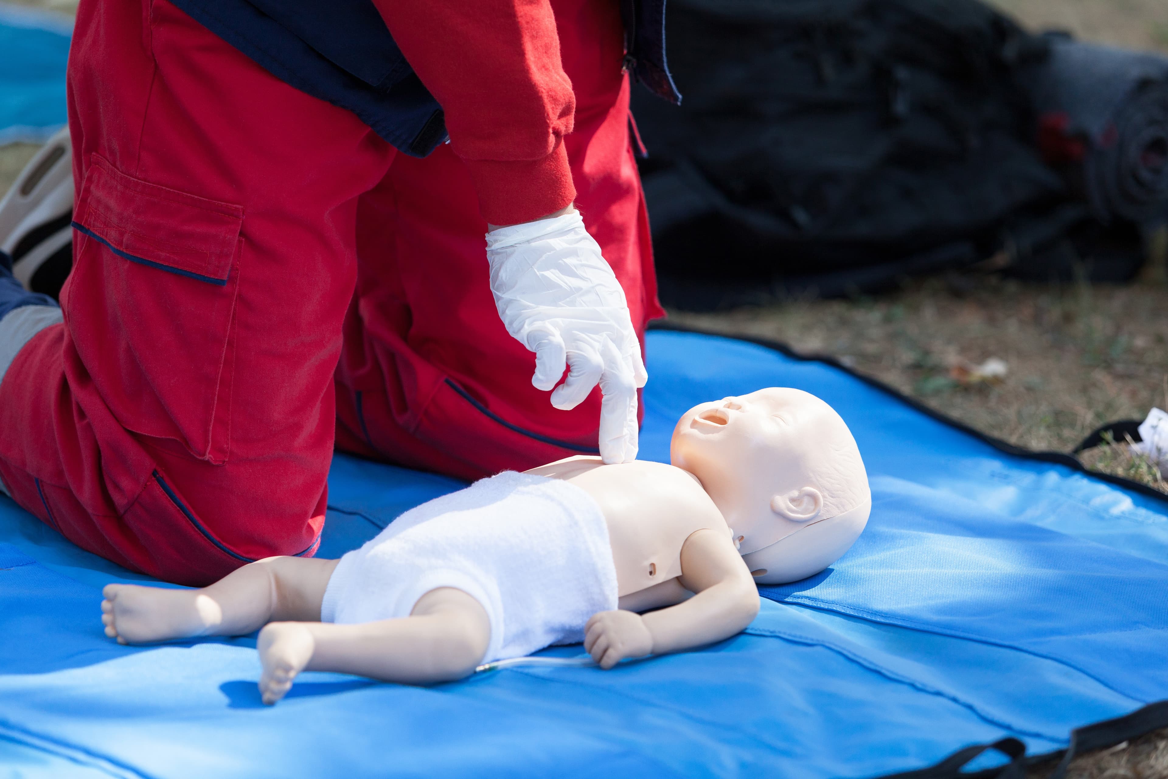 Emergency life support training on an infant doll.
