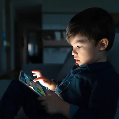 Child looking at a tablet.