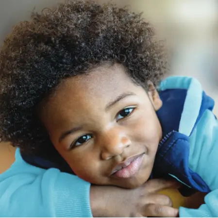 Young boy smiling at camera.