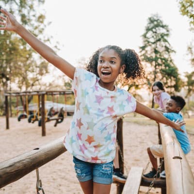 Young girl playing in park.