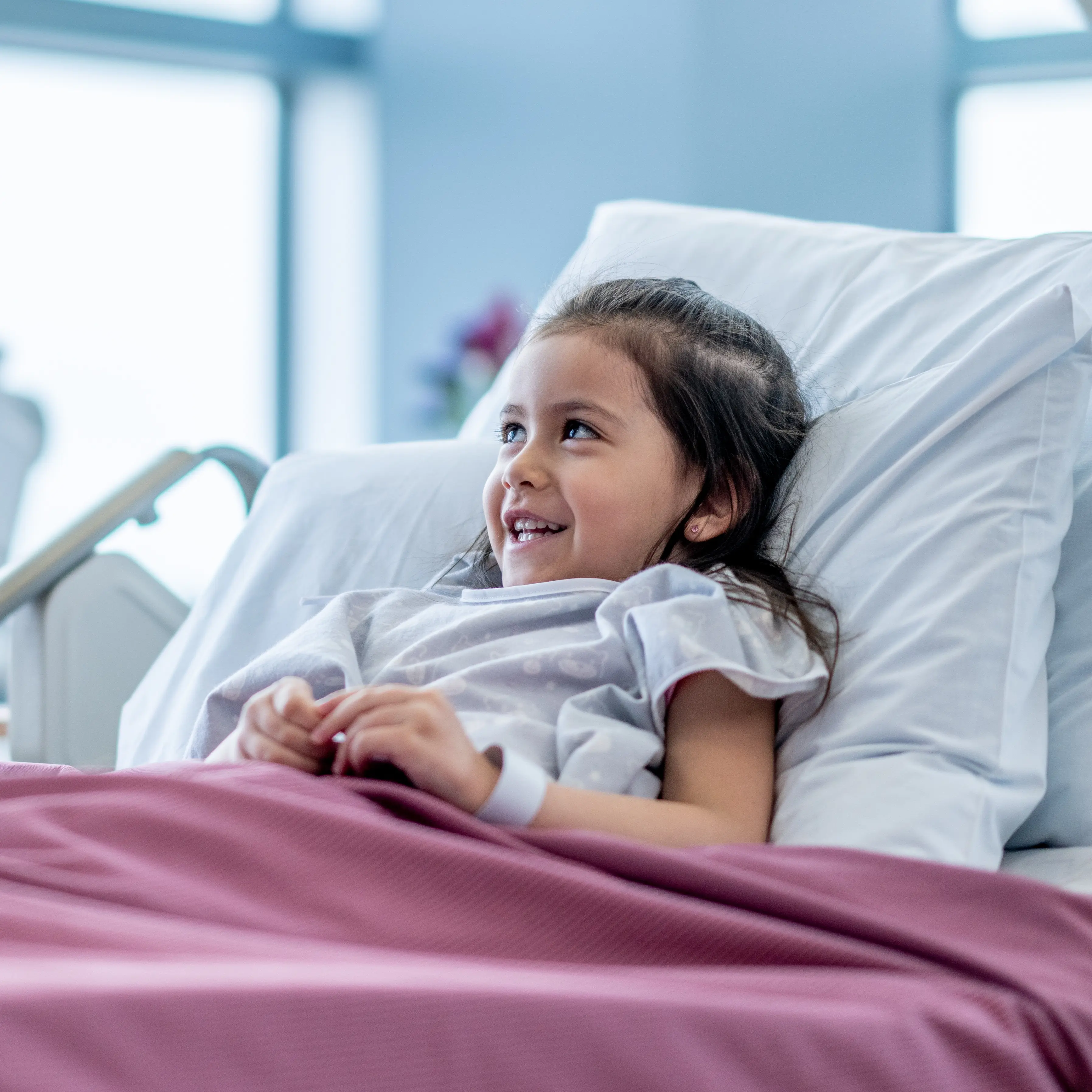 Provider making young patient in the hospital smile.