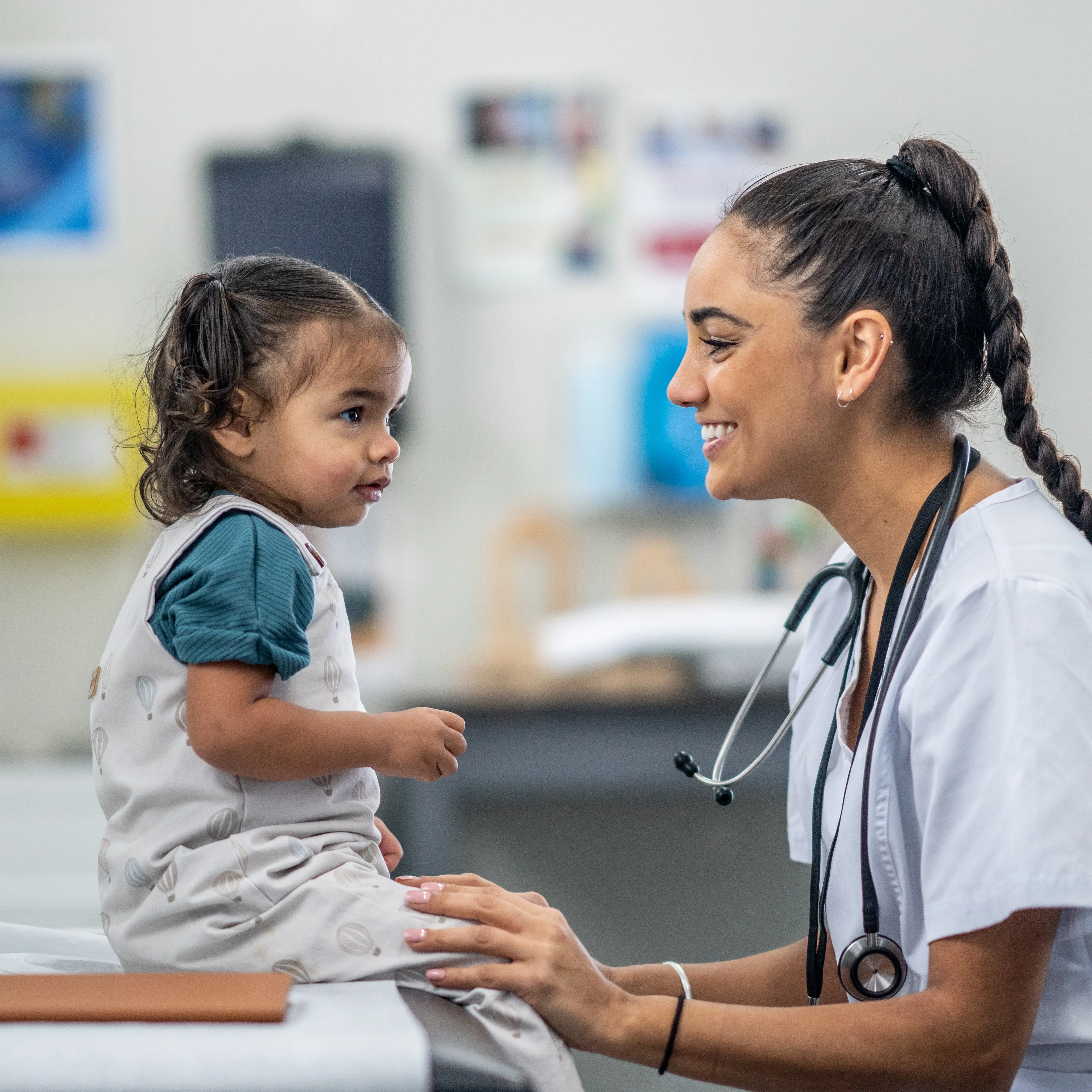 Nurse smiling at young patient.