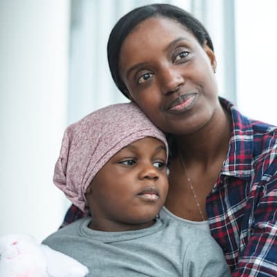 Mother holding child with cancer.
