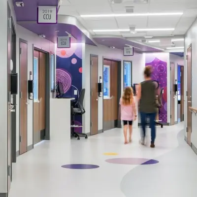 Patient and parent walking down the hallway of a patient floor.