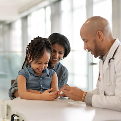 Provider helping patient with finger poke.