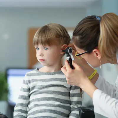 Provider looking in child's ear.