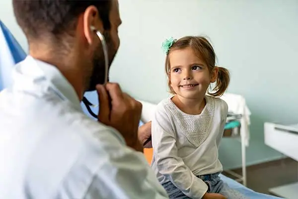 Doctor Examining Girl's Ear With An Otoscope