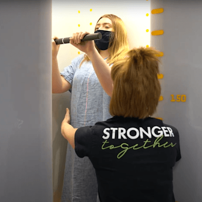 Teenage patient standing in the EOS imaging machine.