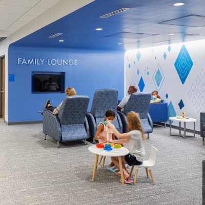 Young patient siblings playing in the family lounge at Children's Nebraska.