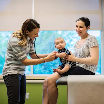 Mother and infant visiting with a Children's doctor.