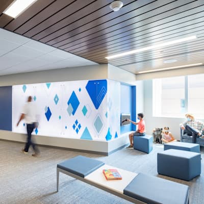 Family sitting in the waiting room on a patient floor in the Hubbard Center for Children.