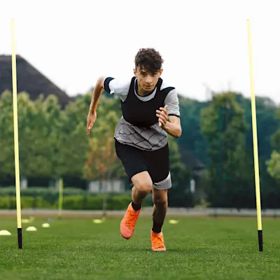 Teen boy at soccer practice.