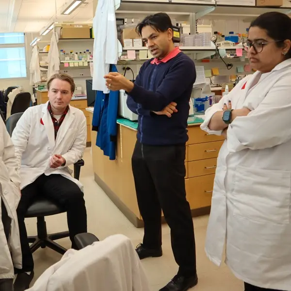 Team of researchers working together in pediatric research lab.