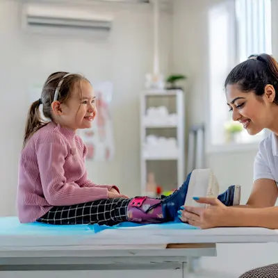 Children's Nebraska provider fitting patient for leg braces.